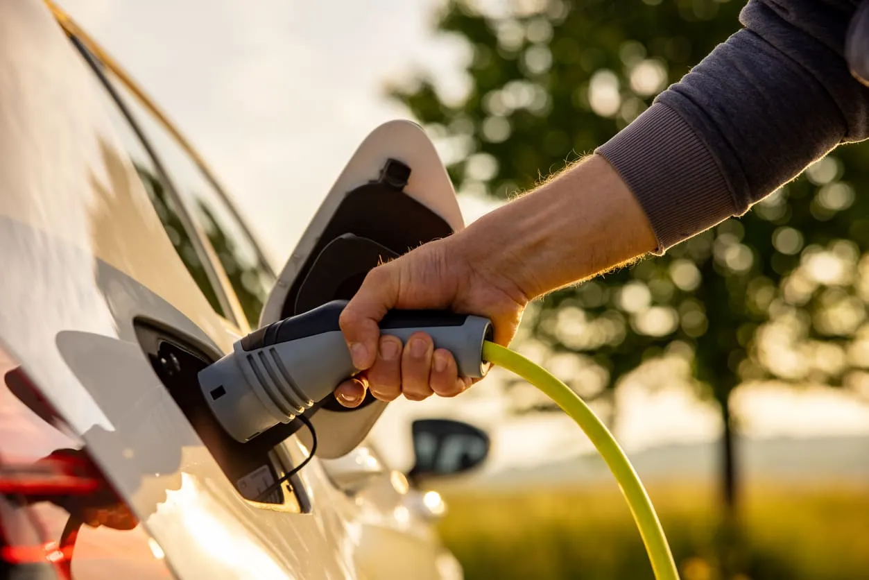 Man's Hand on EV Charger Plug