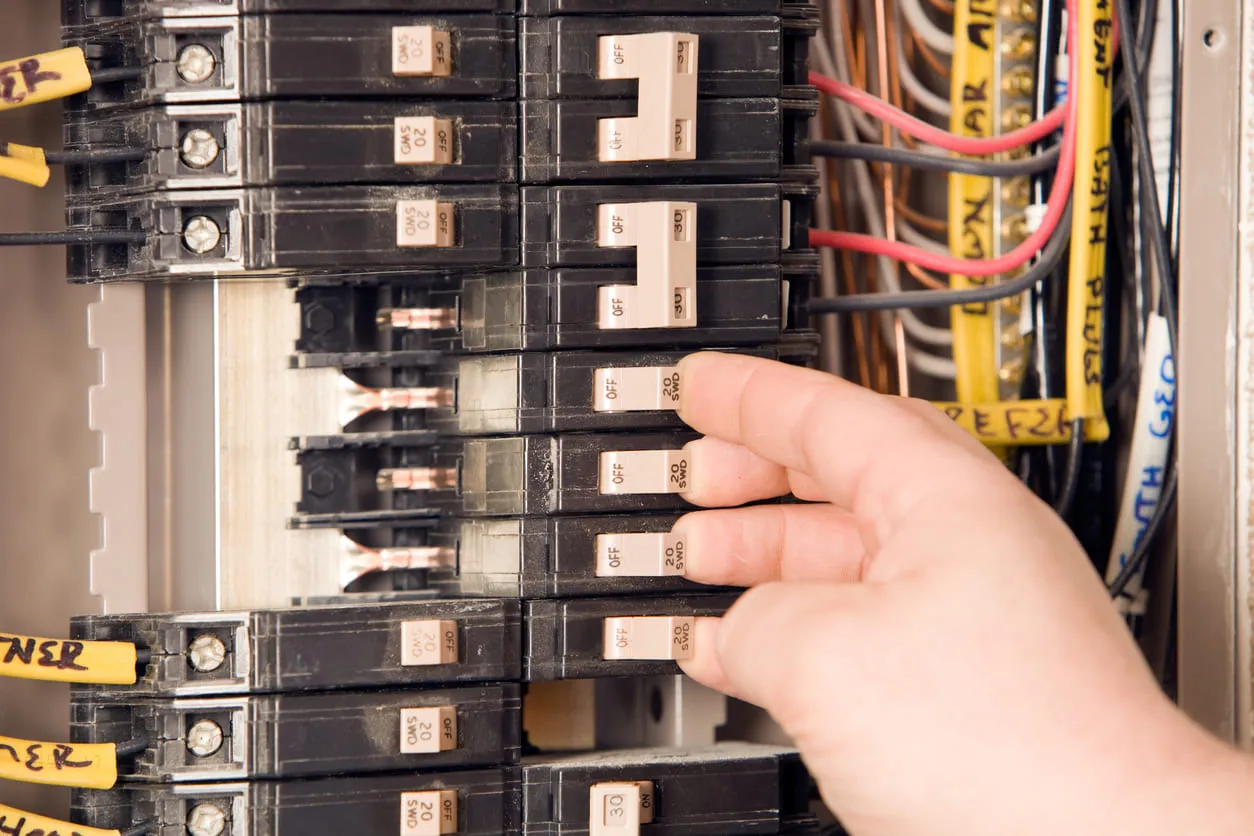 Electrician's Hand on Electrical Panel